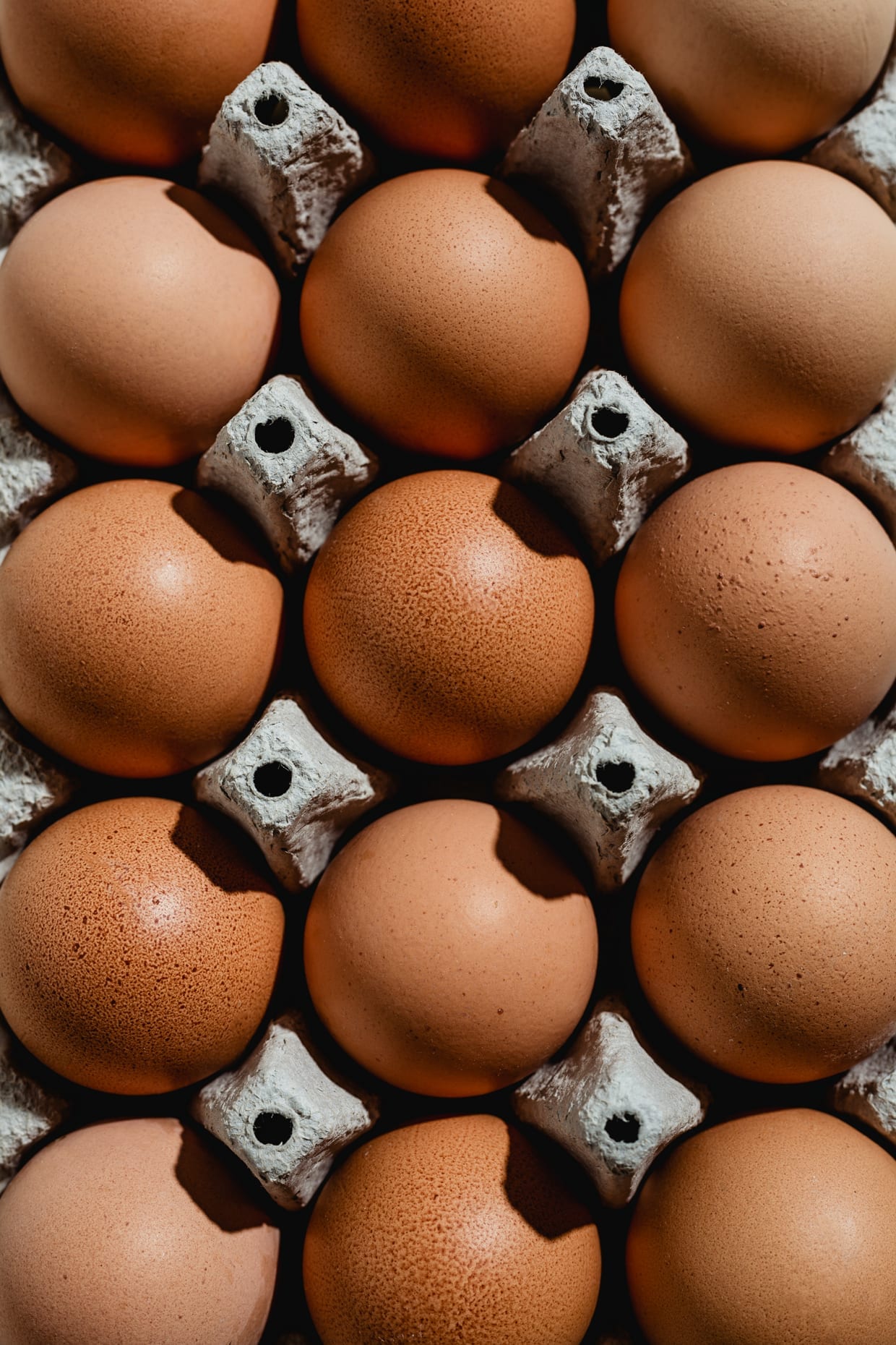Overhead shot of eggs in an egg carton.