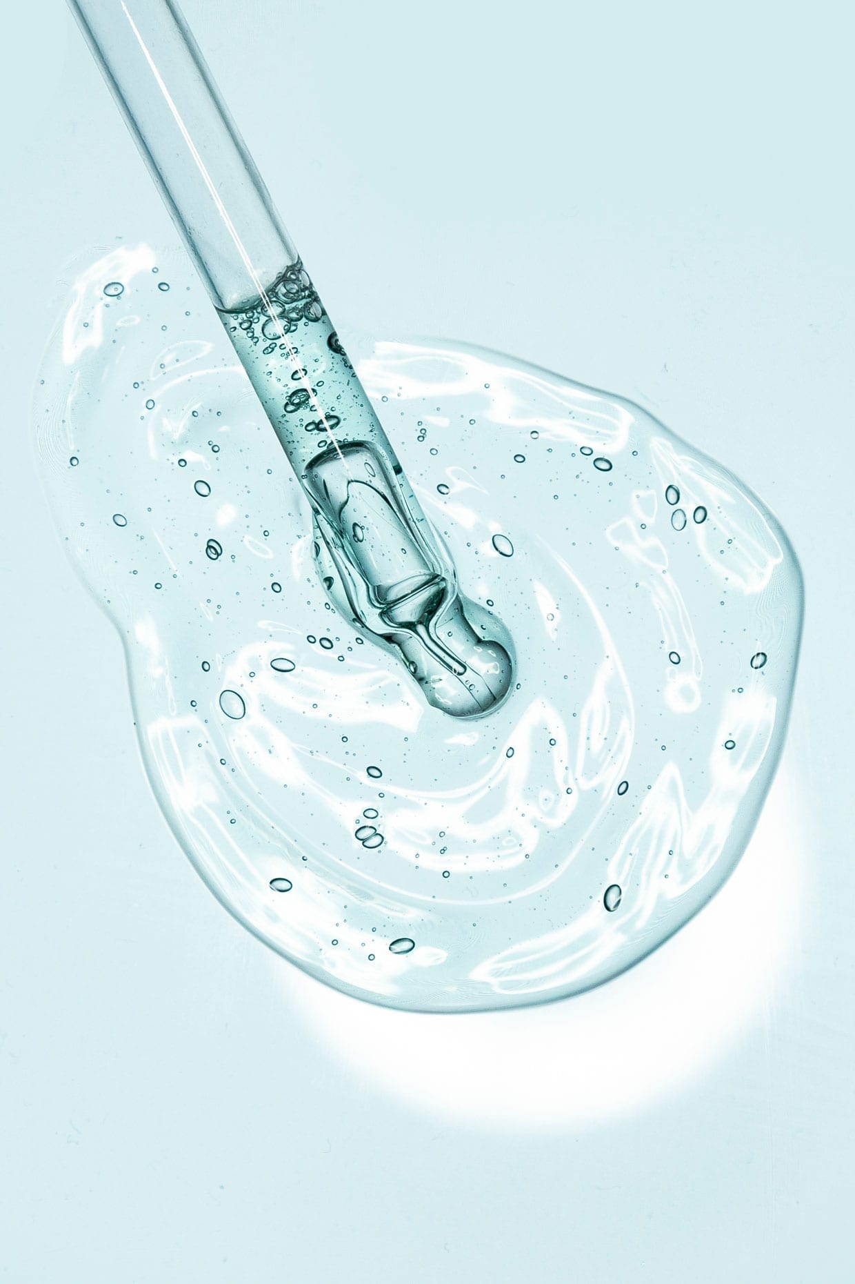 Liquid gel or serum on a screen of microscope white isolated background.